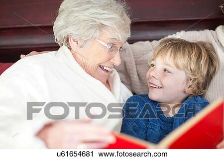 Grandmother and grandson reading in bed View Large Photo Image Stock Image - Grandmother and grandson reading in bed. Fotosearch