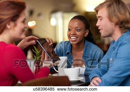 Group of friends in cafe having coffee View Large Photo Image Stock Photography - Group of friends in cafe having coffee. Fotosearch