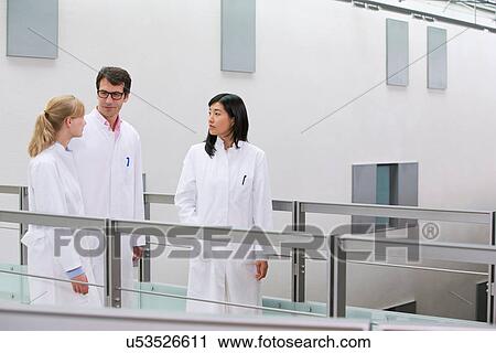 Group of scientists talking in atrium View Large Photo Image Stock Image - Group of scientists talking in atrium. Fotosearch