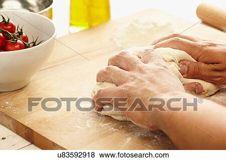 Hands kneading dough View Large Photo Image Stock Photo - Hands kneading dough. Fotosearch