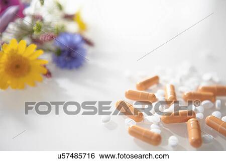 Stock Photograph - Hayfever tablets with wild flowers. Fotosearch