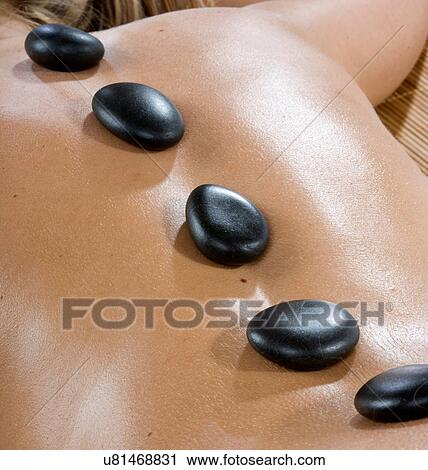 Hot stones on woman's back View Large Photo Image Stock Image - Hot stones on woman's back. Fotosearch