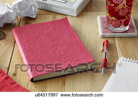 Stock Photo - Kitchen table still life with books, pen and crumpled paper. Fotosearch