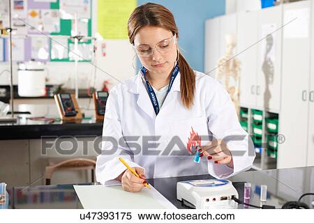 Lab technician holding chemical sample and making notes View Large Photo Image Stock Photography - Lab technician holding chemical sample and making notes. Fotosearch