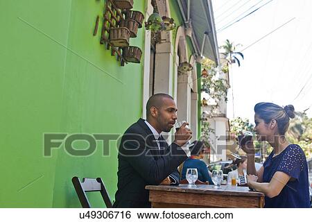 Man and woman having wine outside cafe View Large Photo Image Stock Photograph - Man and woman having wine outside cafe. Fotosearch