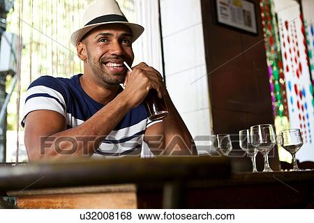 Man in cafe with a drink View Large Photo Image Stock Photo - Man in cafe with a drink. Fotosearch