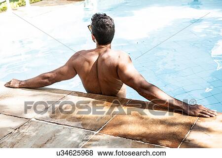 Man in swimming pool leaning with arms outstretched View Large Photo Image Stock Photo - Man in swimming pool leaning with arms outstretched. Fotosearch