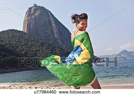Man on beach with Brazilian flag, Rio de Janeiro, Brazil View Large Photo Image Stock Image - Man on beach with Brazilian flag, Rio de Janeiro, Brazil. Fotosearch
