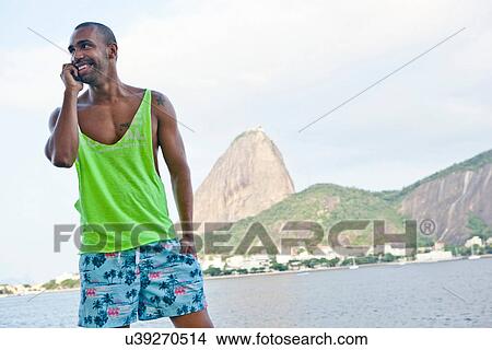 Picture - Man on cell phone, Rio de Janeiro, Brazil. Fotosearch