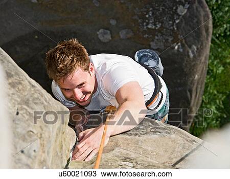 Man on top rope climbing sandstone butte View Large Photo Image Stock Image - Man on top rope climbing sandstone butte. Fotosearch