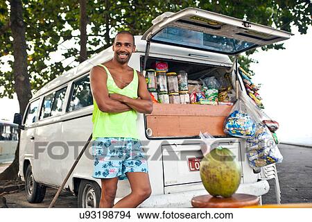 Picture - Man selling confectionary from campervan. Fotosearch