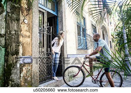 Man with bicycle talking to woman in doorway, Rio de Janeiro, Brazil View Large Photo Image Stock Image - Man with bicycle talking to woman in doorway, Rio de Janeiro, Brazil. Fotosearch