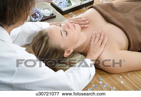 Masseuse giving shoulder massage at spa View Large Photo Image Stock Photo - Masseuse giving shoulder massage at spa. Fotosearch