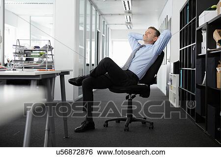 Mature businessman leaning back in office chair View Large Photo Image Stock Photograph - Mature businessman leaning back in office chair. Fotosearch