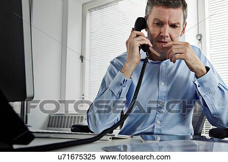 Mature businessman on landline phone View Large Photo Image Stock Photography - Mature businessman on landline phone. Fotosearch