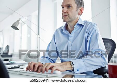 Mature businessman using computer View Large Photo Image Stock Image - Mature businessman using computer. Fotosearch