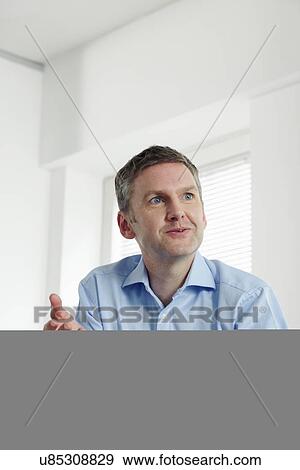 Mature businessman with paperwork View Large Photo Image Stock Photo - Mature businessman with paperwork. Fotosearch