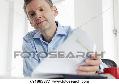 Mature businessman with paperwork View Large Photo Image Stock Photo - Mature businessman with paperwork. Fotosearch