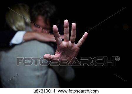 Mature man holding up hand whilst hugging woman View Large Photo Image Stock Image - Mature man holding up hand whilst hugging woman. Fotosearch