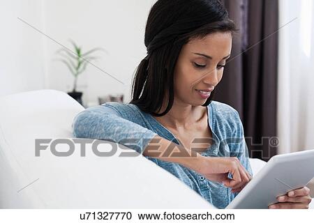 Stock Image - Mature woman using digital tablet. Fotosearch