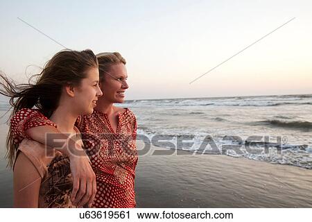 Mother and daughter looking at ocean View Large Photo Image Stock Image - Mother and daughter looking at ocean. Fotosearch