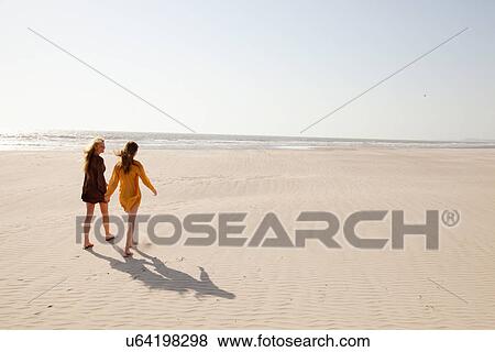 Mother and daughter walking on beach View Large Photo Image Stock Photo - Mother and daughter walking on beach. Fotosearch