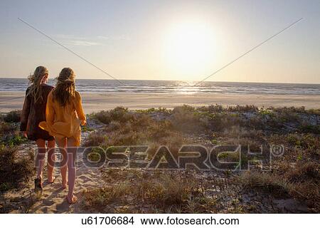 Mother and daughter walking towards beach View Large Photo Image Picture - Mother and daughter walking towards beach. Fotosearch