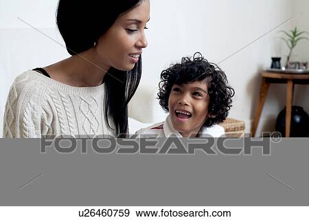 Stock Photo - Mother and son looking at book. Fotosearch