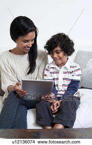 Mother and son using digital tablet View Large Photo Image Picture - Mother and son using digital tablet. Fotosearch