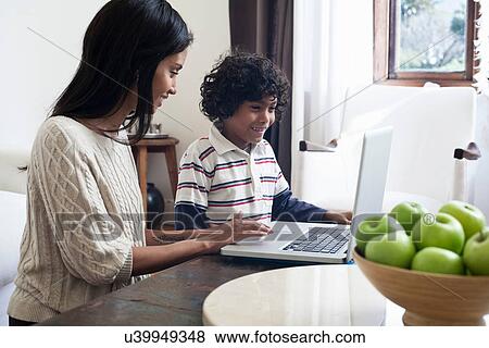 Mother and son using laptop View Large Photo Image Stock Photo - Mother and son using laptop. Fotosearch