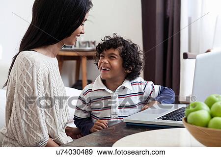 Stock Photo - Mother and son using laptop. Fotosearch