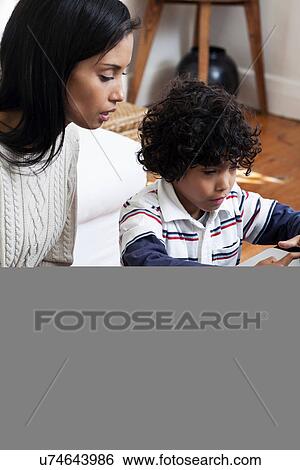 Mother and son using laptop View Large Photo Image Stock Photograph - Mother and son using laptop. Fotosearch
