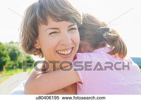 Mother holding daughter, smiling View Large Photo Image Stock Photography - Mother holding daughter, smiling. Fotosearch