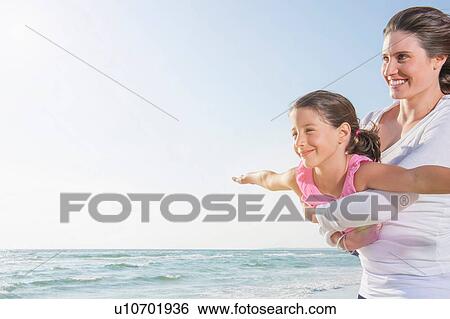 Mother holding girl with arms open View Large Photo Image Stock Photograph - Mother holding girl with arms open. Fotosearch