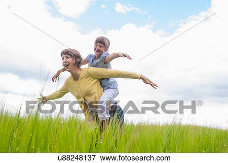 Mother with daughter pretending to be airplanes View Large Photo Image Stock Photo - Mother with daughter pretending to be airplanes. Fotosearch