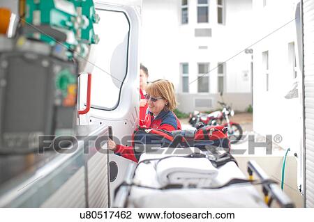 Stock Image - Paramedic opening ambulance door. Fotosearch