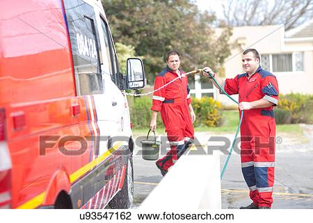 Paramedics cleaning ambulance with hosepipe View Large Photo Image Stock Image - Paramedics cleaning ambulance with hosepipe. Fotosearch