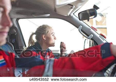 Stock Image - Paramedics driving to emergency in ambulance. Fotosearch