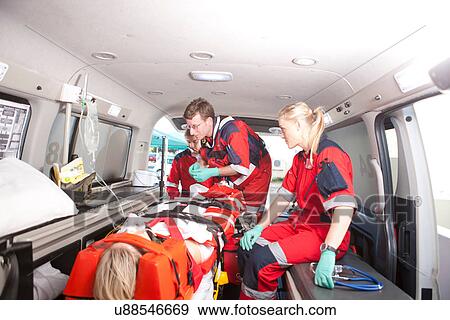 Paramedics in ambulance working with patient View Large Photo Image Stock Photo - Paramedics in ambulance working with patient. Fotosearch