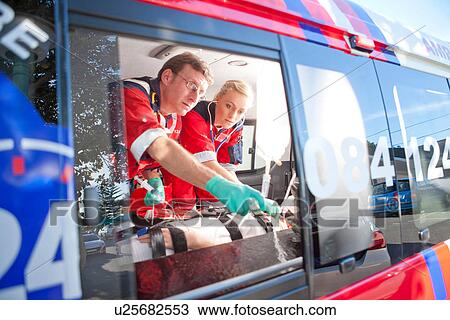 Paramedics monitoring patient in ambulance View Large Photo Image Stock Image - Paramedics monitoring patient in ambulance. Fotosearch