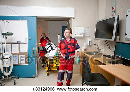 Paramedics moving patient to emergency room in hospital View Large Photo Image Stock Photograph - Paramedics moving patient to emergency room in hospital. Fotosearch