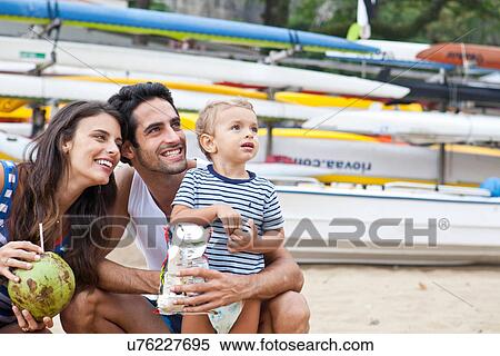 Parents with young son looking away, smiling View Large Photo Image Stock Photography - Parents with young son looking away, smiling. Fotosearch