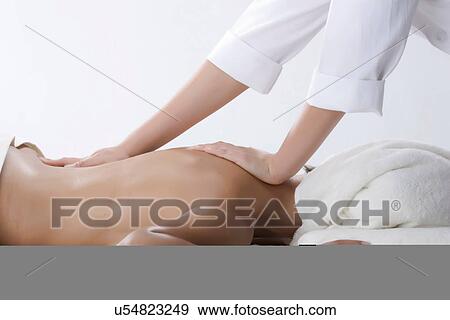 Person massaging woman's back View Large Photo Image Stock Photo - Person massaging woman's back. Fotosearch