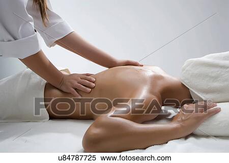 Stock Photography - Person massaging woman's back. Fotosearch