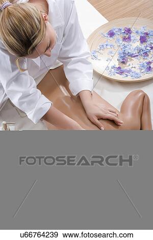 Stock Photo - Person massaging woman's shoulders. Fotosearch