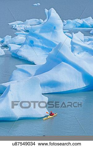 Person sea kayaking on Grey Lake, Torres del Paine National Park, Patagonia, Chile View Large Photo Image Picture - Person sea kayaking on Grey Lake, Torres del Paine National Park, Patagonia, Chile. Fotosearch