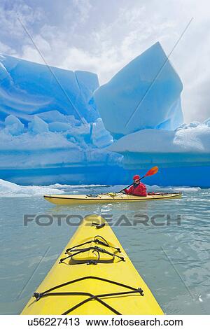 Stock Image - Person sea kayaking on Grey Lake, Torres del Paine National Park, Patagonia, Chile. Fotosearch