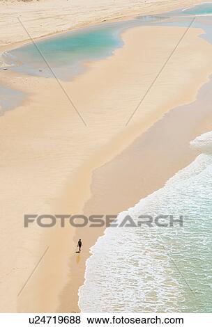 Stock Photo - Person walking on Seventy-five Miles Beach, Fraser Island, Queensland, Australia. Fotosearch