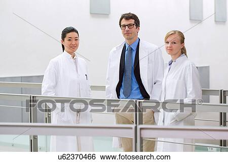 Stock Photograph - Portrait of a group of scientists in laboratory atrium. Fotosearch