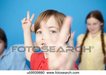 Portrait of boy making peace sign View Large Photo Image Stock Image - Portrait of boy making peace sign. Fotosearch